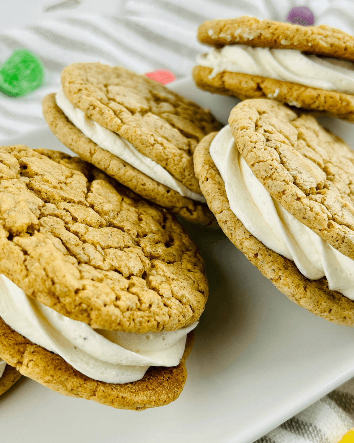 A white platter of the gingerbread sugar cookies with eggnog frosting.