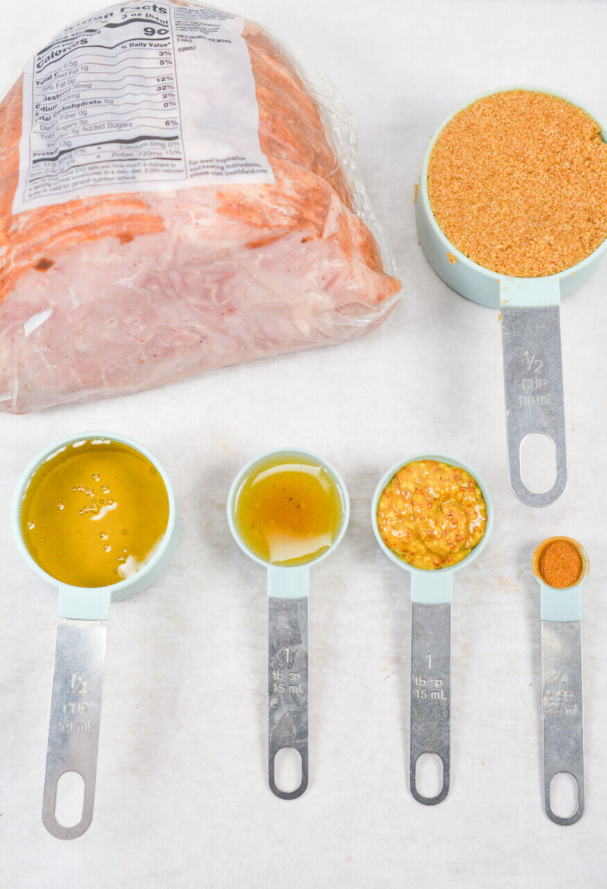 Ingredients measured in cups and spoons, including red lentils, oil, garlic paste, and spices, laid out next to an air fryer ham.