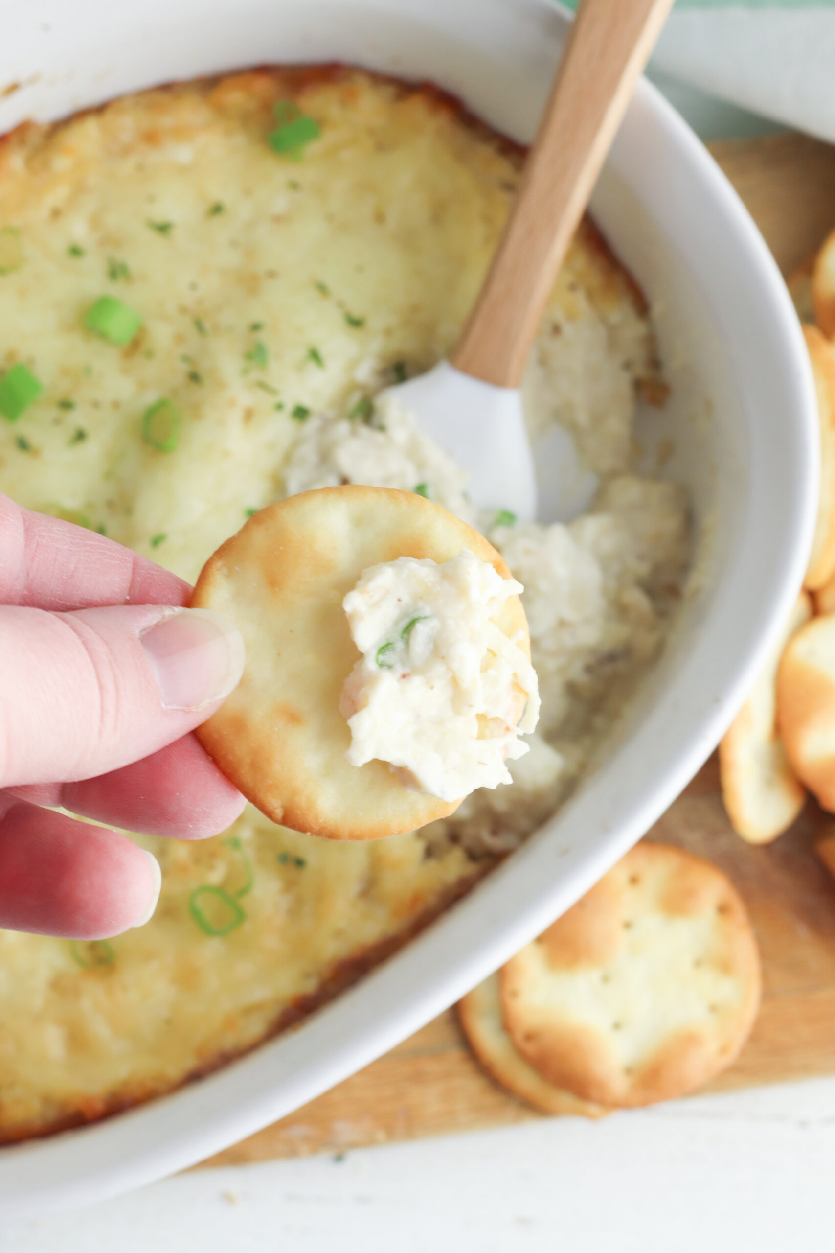 A cracker with the crab dip on it.