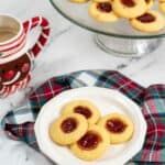 A plate of strawberry jam cookie thumprints.