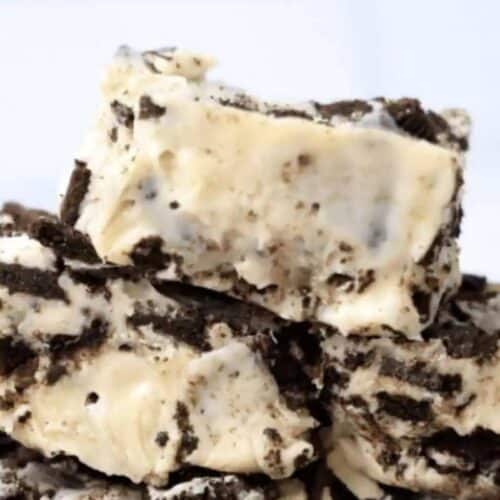 Close-up of Old Fashioned Fudge pieces, featuring a creamy white base packed with chunks of chocolate cookies for a classic cookies and cream treat.