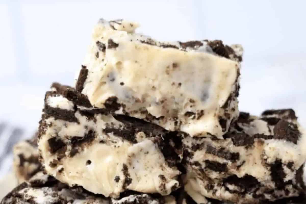 Close-up of Oreo fudge pieces, featuring a creamy white base packed with chunks of chocolate cookies for a classic cookies and cream treat.