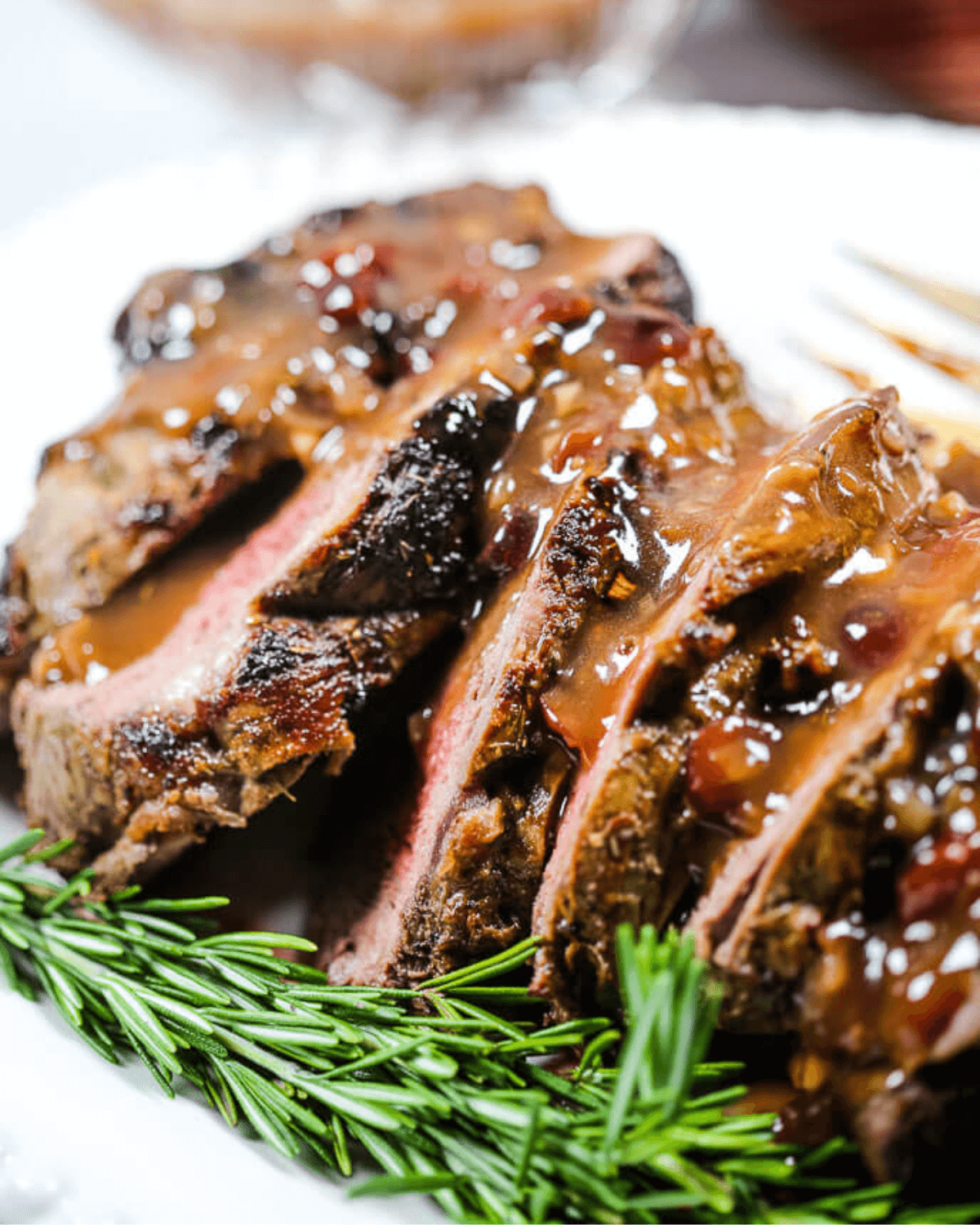 A close up on the beef with the sauce on it.