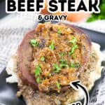 A slice of smothered steak and gravy topped with onion gravy, garnished with parsley, served over mashed potatoes on a black plate. Text overlay reads "Smothered Beef Steak & Gravy, Big Flavor.