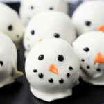 A tray of cute snowman oreo balls.