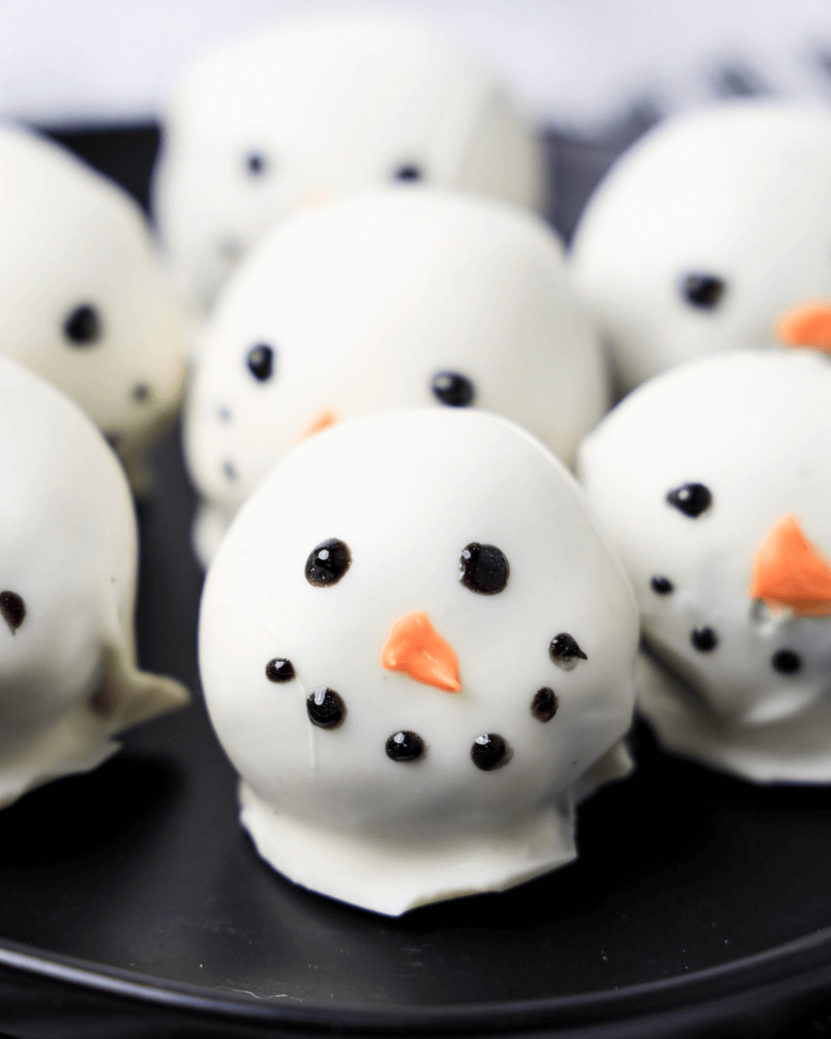 A tray of cute snowman oreo balls.