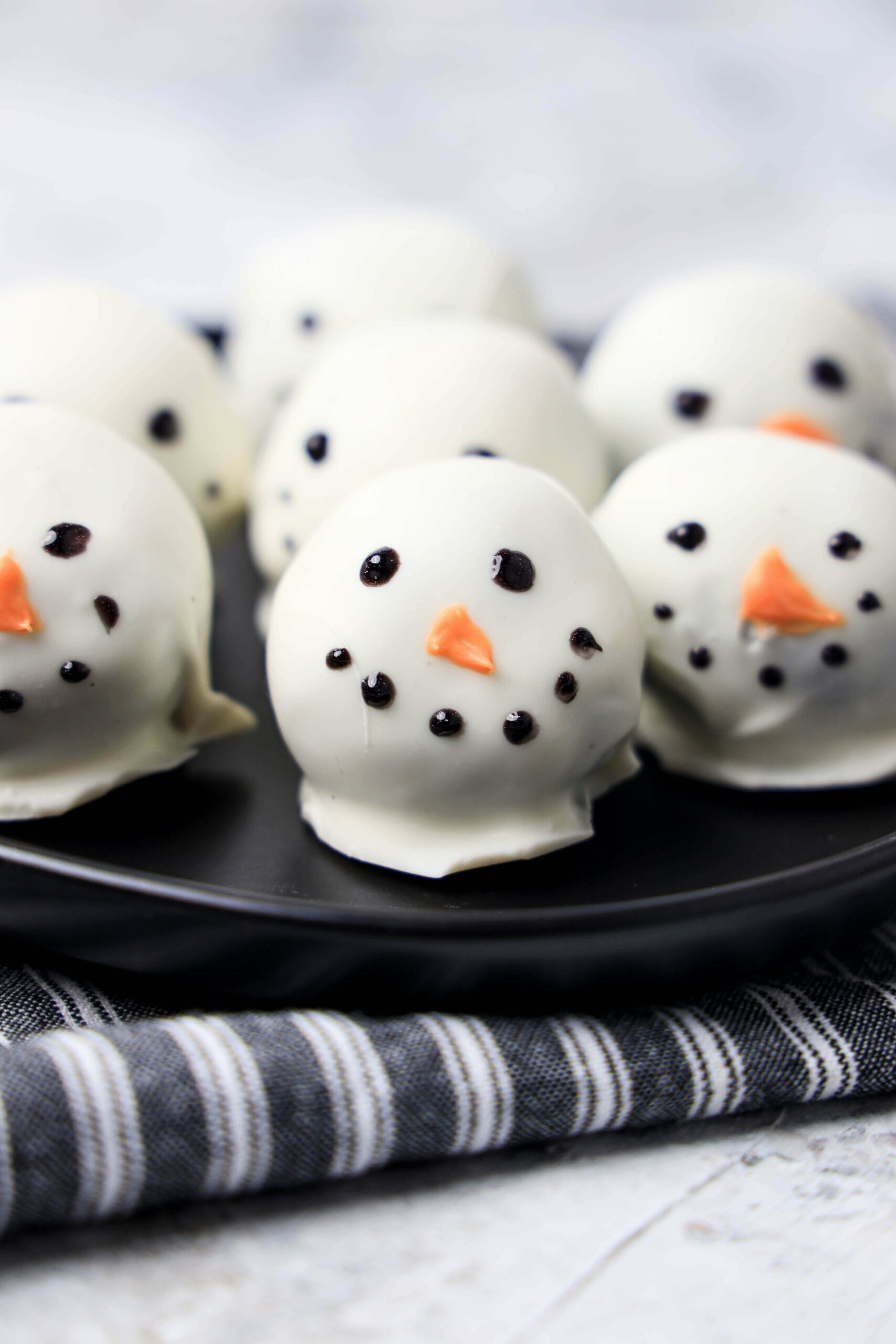 Snowman Oreo Balls with happy faces.