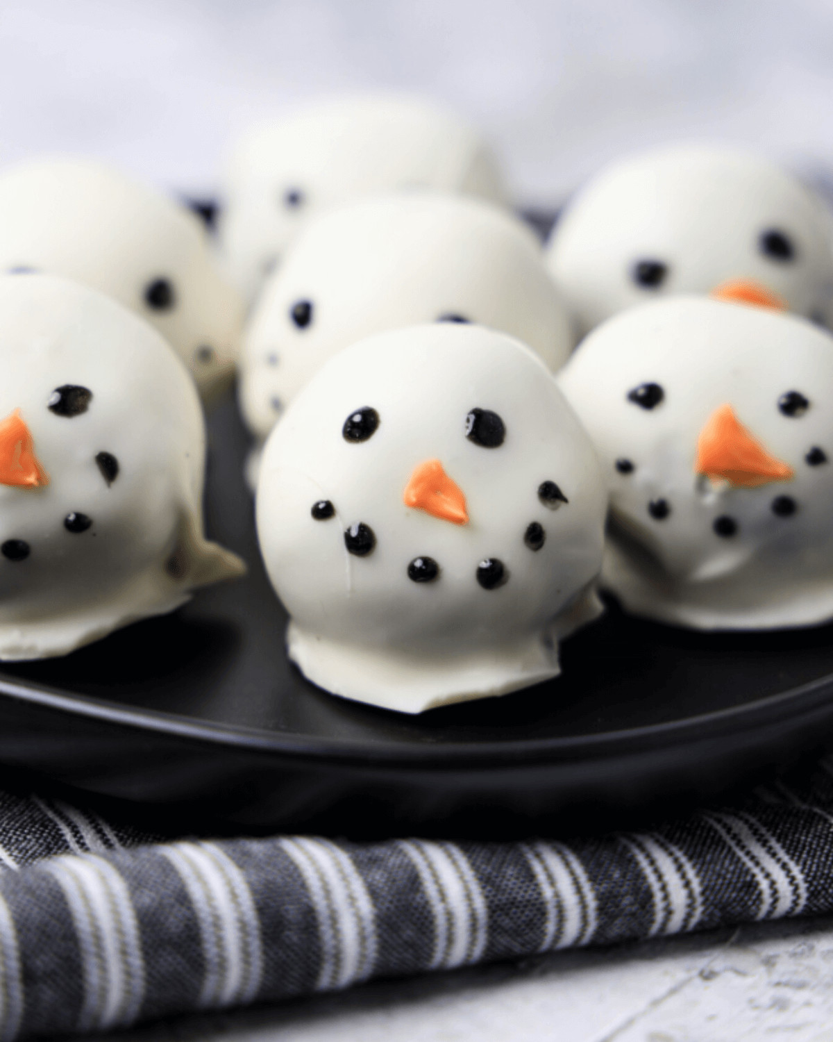 A smiling snowman oreo ball.