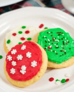 soft frosted sugar cookies on a white plate.