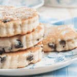 A stack of three sugar-dusted welsh cookies.