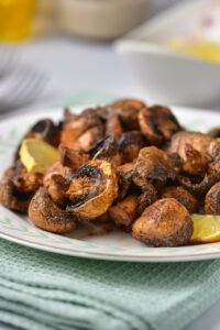 A close up view of the air fryer mushrooms with lemon.