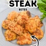A plate of breaded Air Fryer Steak Bites is shown on a gray dish, garnished with fresh parsley. Bold text reads "Air Fryer Steak Bites Juicy.