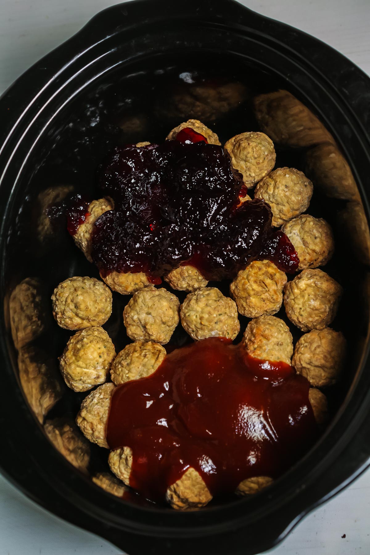 Barbecue meatballs cooked in a crock pot with sauce.