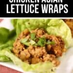 Close-up of Asian Lettuce Wraps filled with savory chicken and topped with chopped green onions, served on a white plate over a red textured mat.