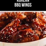 A plate of crispy Korean BBQ wings, generously sprinkled with sesame seeds, delivers a savory punch.