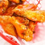 A basket of the appetizer served on wax paper, delivering that irresistible spicy kick.