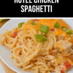 A plate of rotel chicken spaghetti, richly topped with cheese and garnished with freshly chopped green onions.