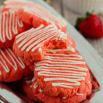 Strawberry Cake Mix Cookies with a drizzle of white icing.