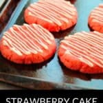 A baking tray with round, pink Strawberry Cake Mix Cookies drizzled with white icing. Text at the bottom reads "Strawberry Cake Mix Cookies.
