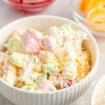 A serving bowl of the creamy side dish with marshmallows.