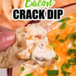 A person holding a piece of bread with cowboy crack dip.