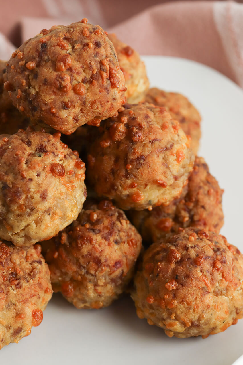 A stack of the breakfast meatballs on a white dish.