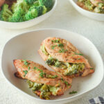 A side view of the chicken with broccoli on the side.