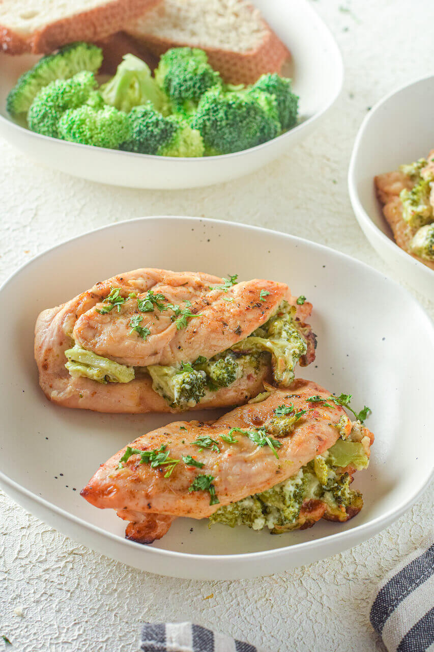 Two chicken breasts with broccoli.
