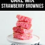 A stack of pink Cake Mix Strawberry Brownies sits on a white plate.