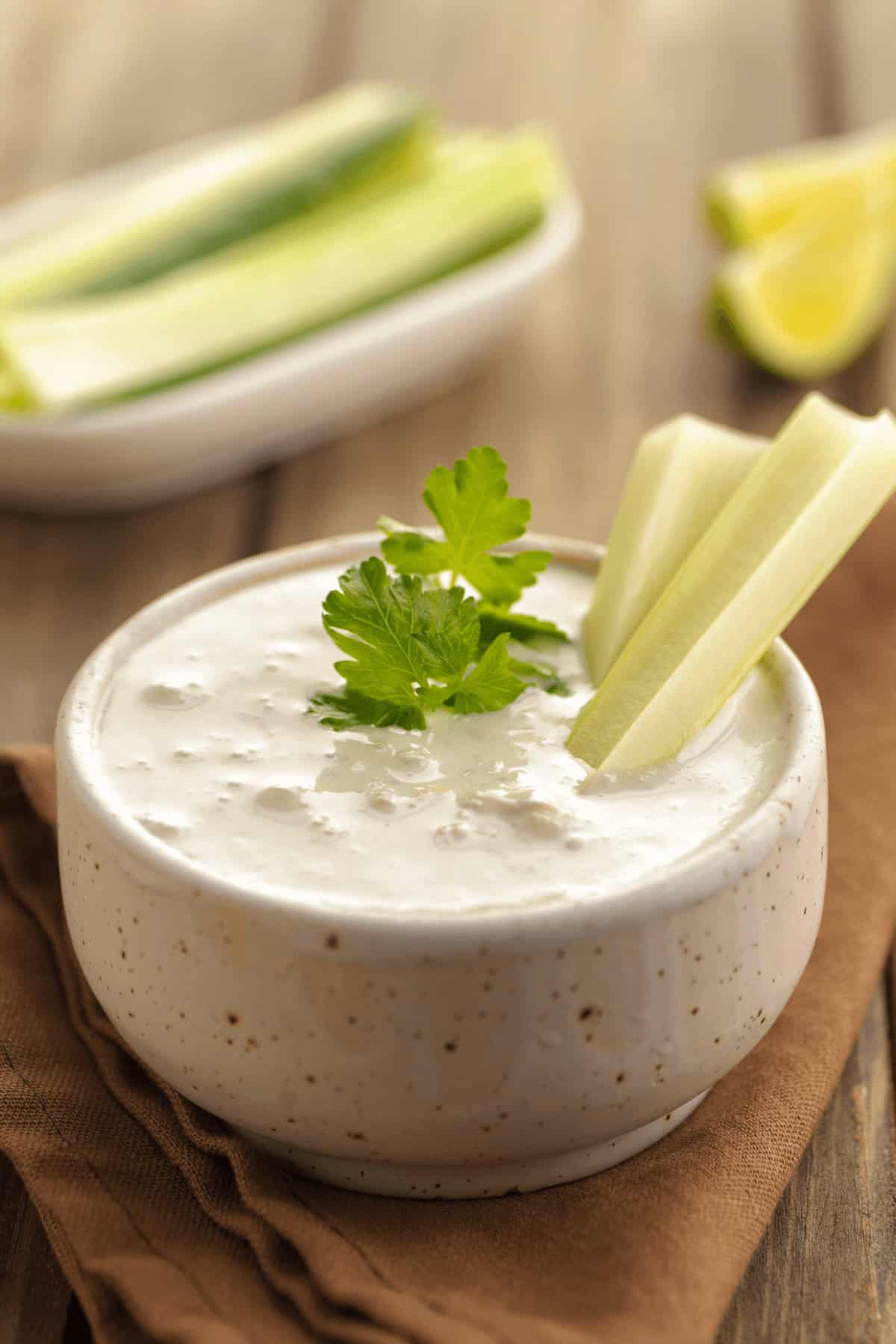 Celery in a dish of the dressing.