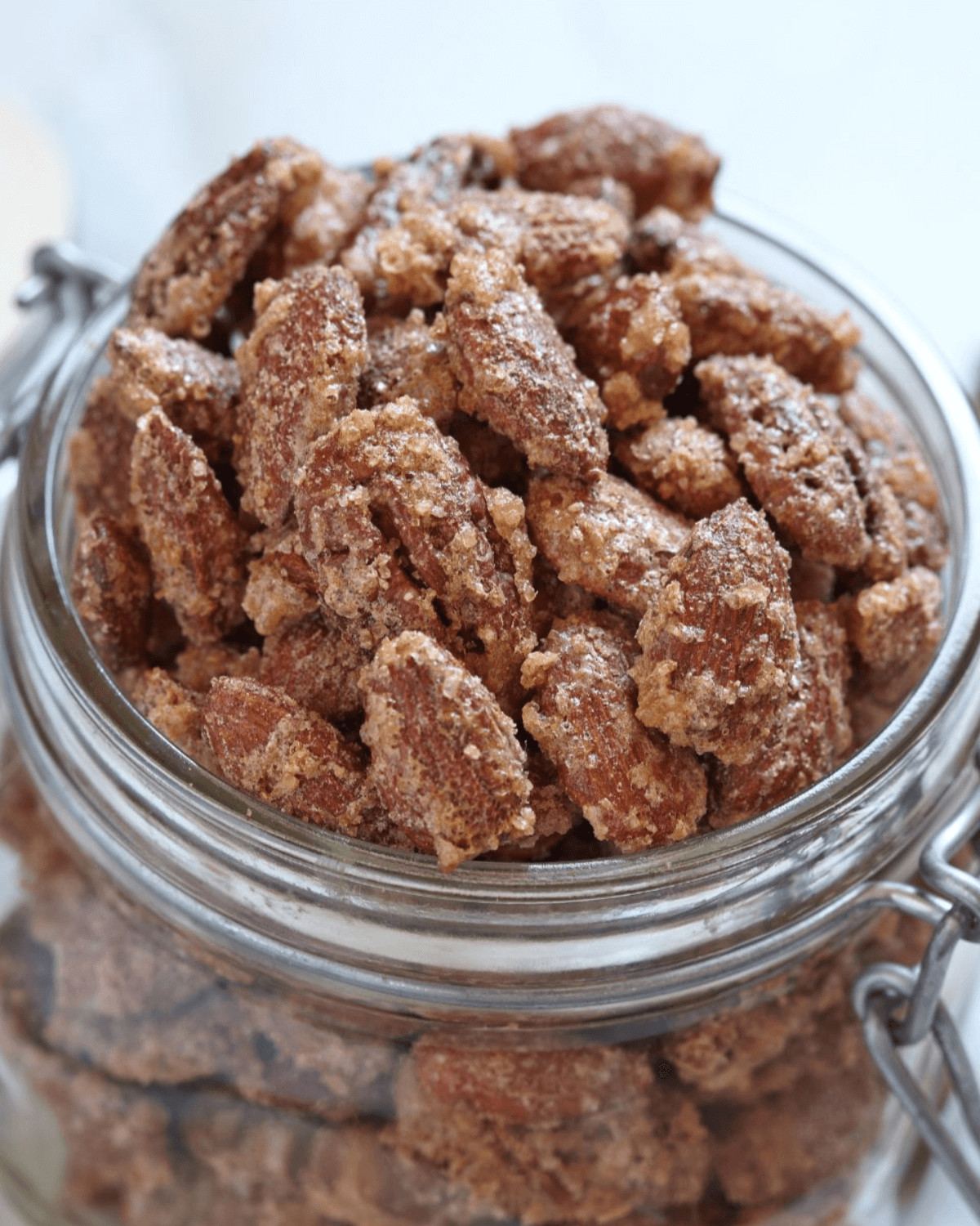 A glass jar of the cinnamon roasted nuts.