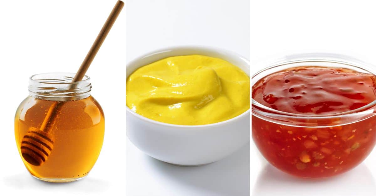 A jar of spicy honey with a dipper, a bowl of zesty mustard, and a saucy red blend speckled with chili flakes are displayed side by side.