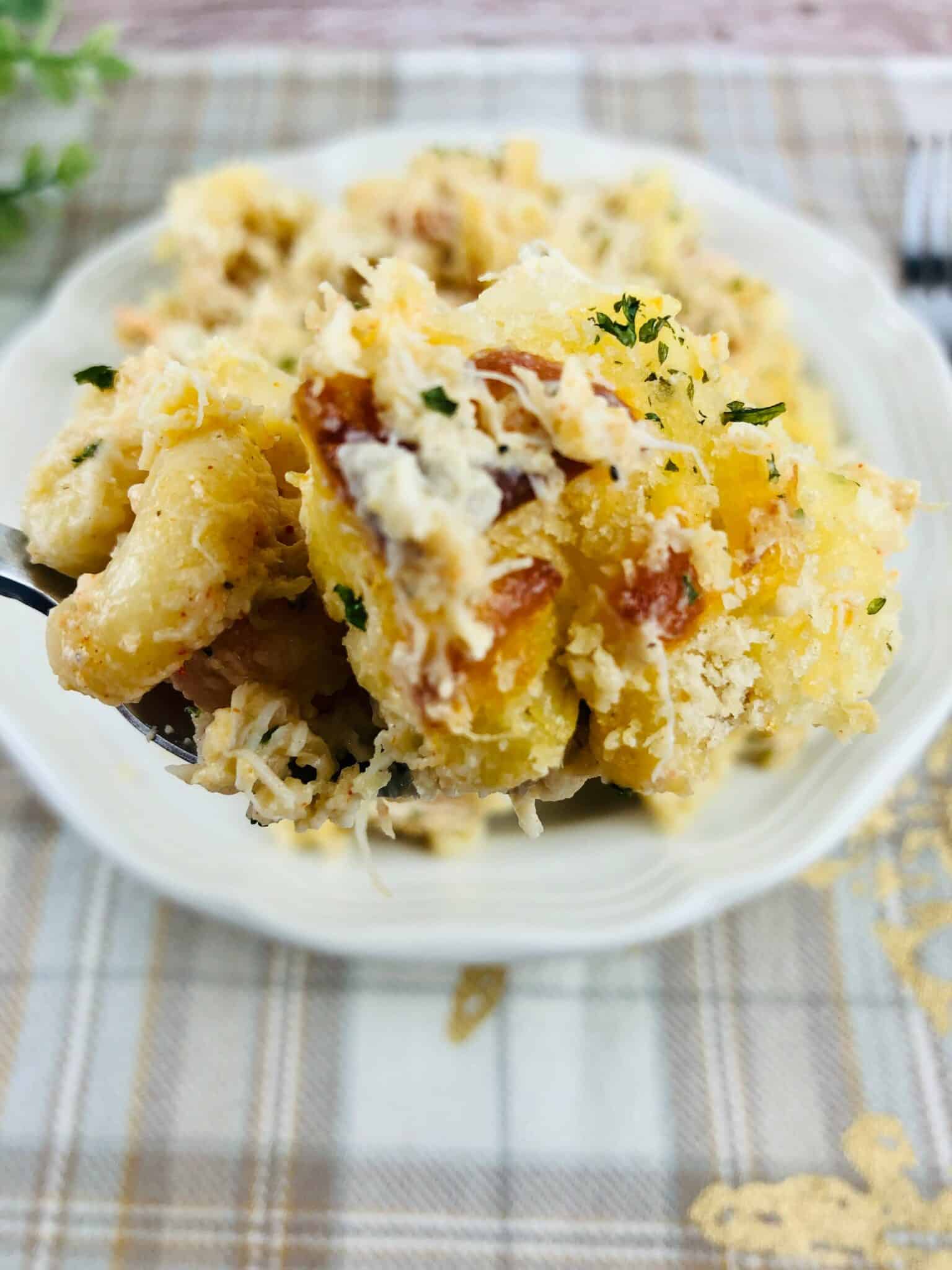 A white plate loaded with the seafood mac and cheese.