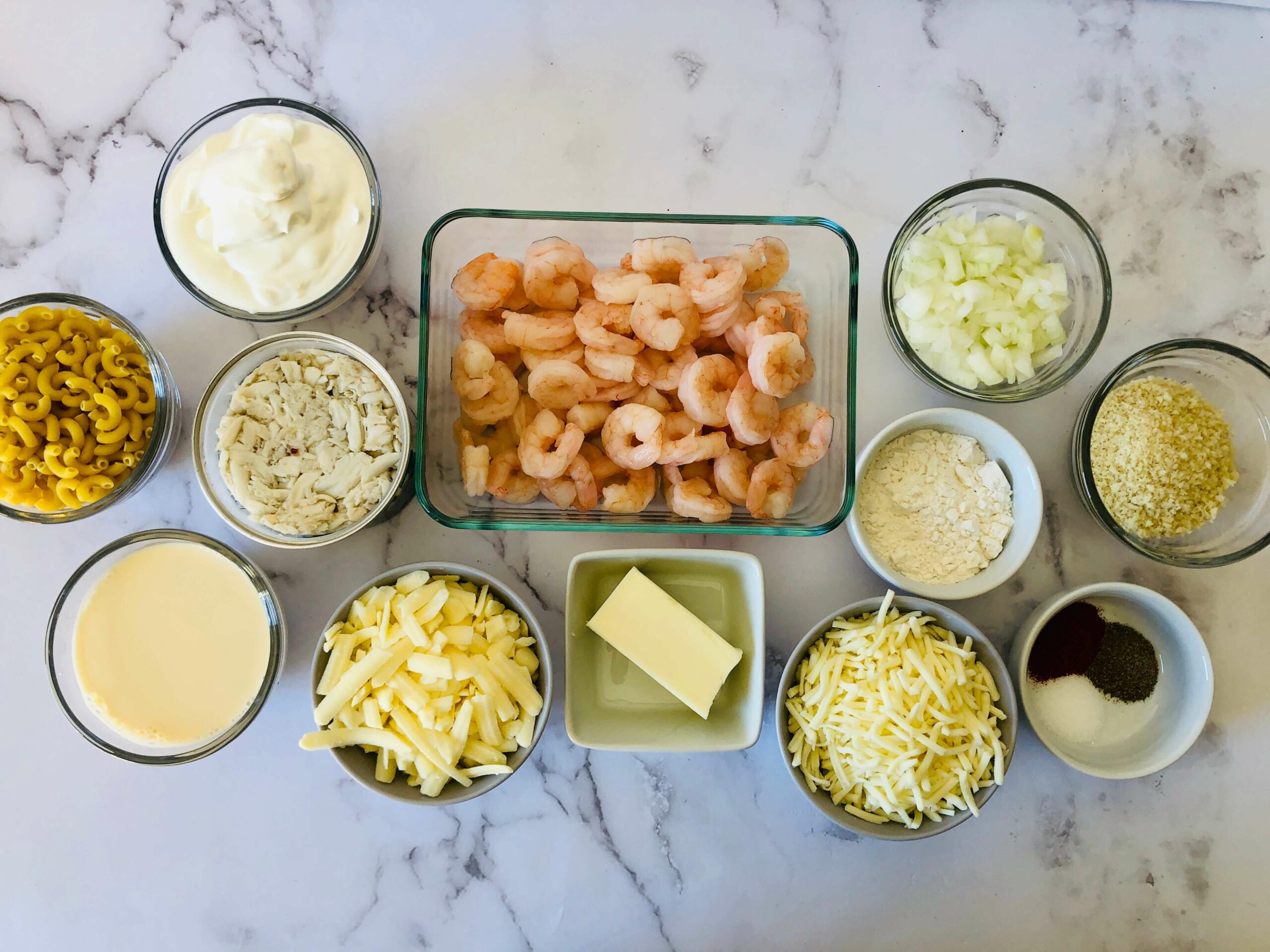 Pasta, cheese seafood butter and ingredients to make the dish.