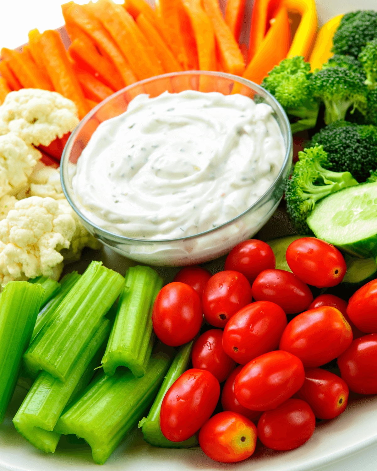 A plate of vegetables with Sour Cream and Ranch Dip.