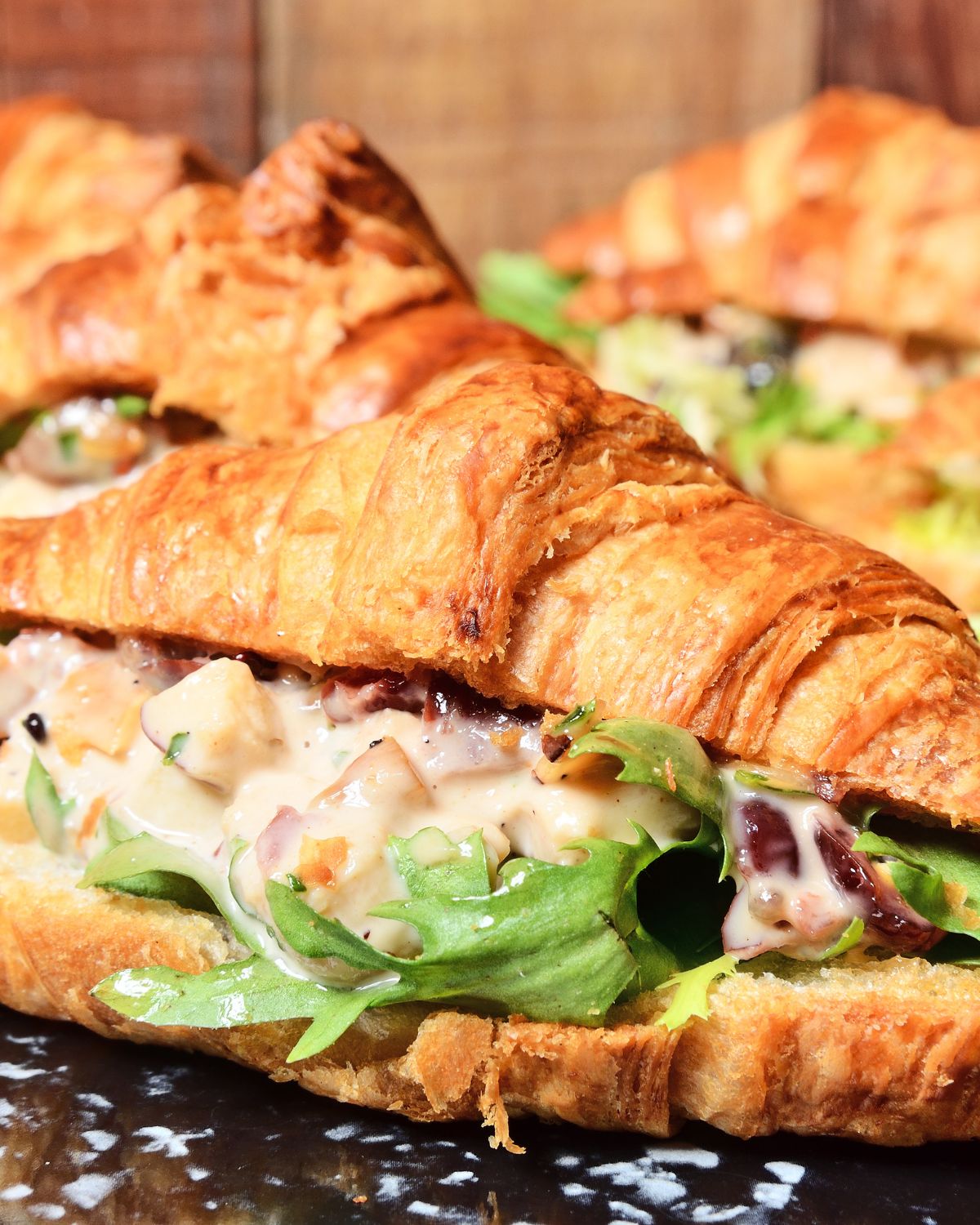 A croissant with taco shrimp salad sandwich.