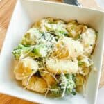 The pasta in the sauce with parmesan on top.