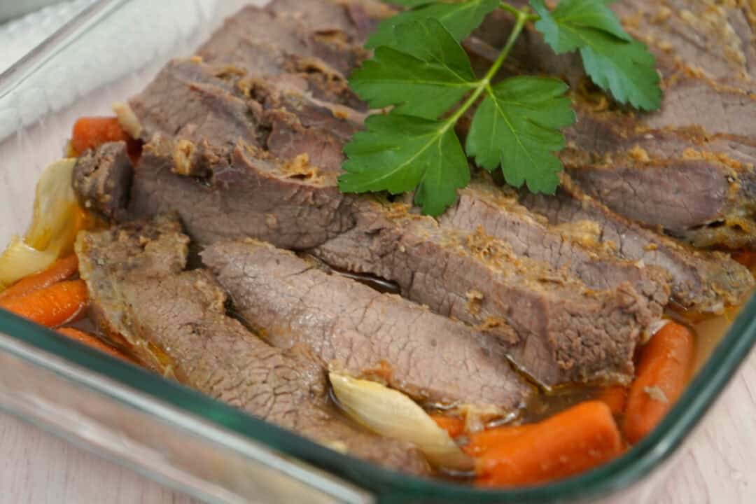 Oven brisket with several slices out.