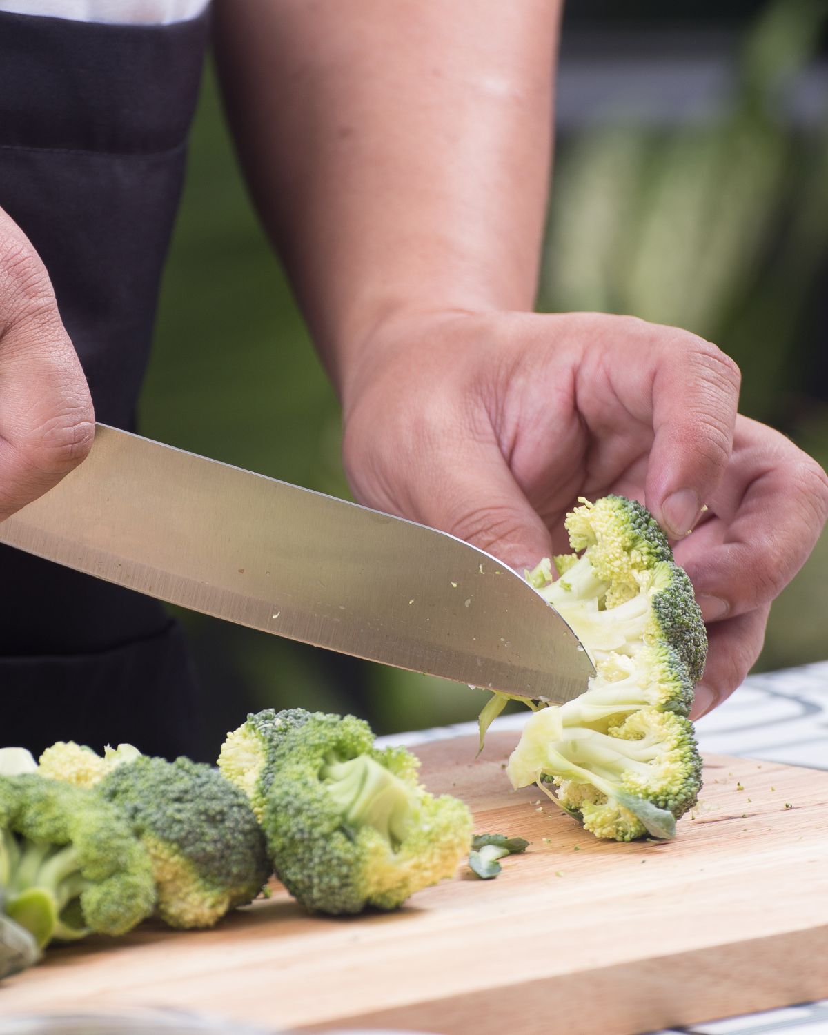 Cutting close to the heads of the broccoli.