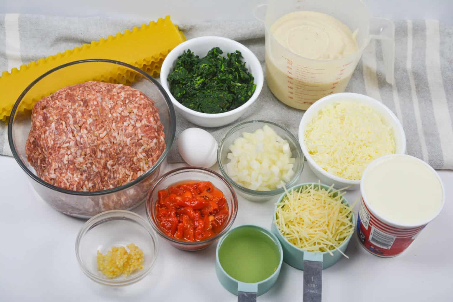 Vegetables, sauce, cheese and noodles.