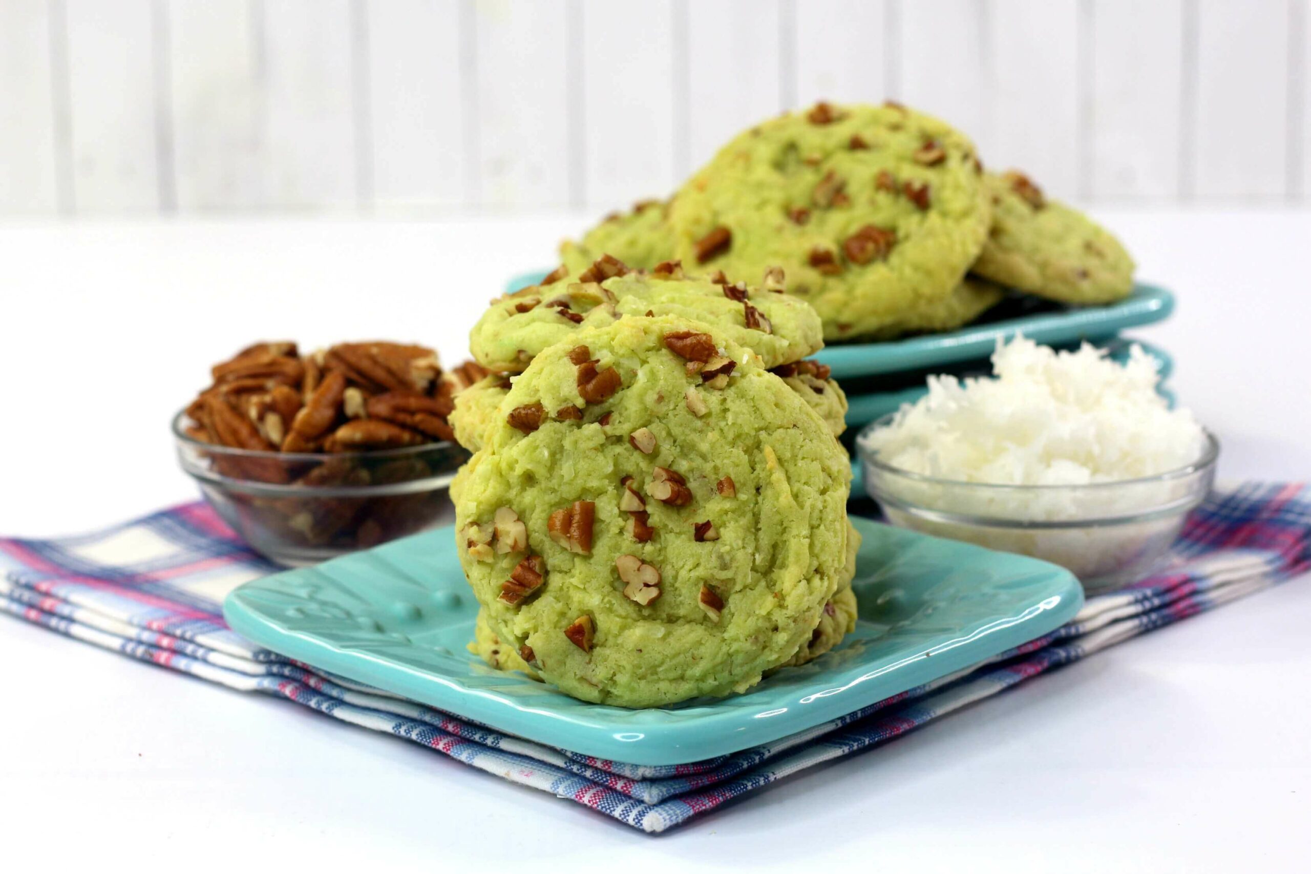 A platter of the finished watergate pistachio cookies with on cookie featured on its side.