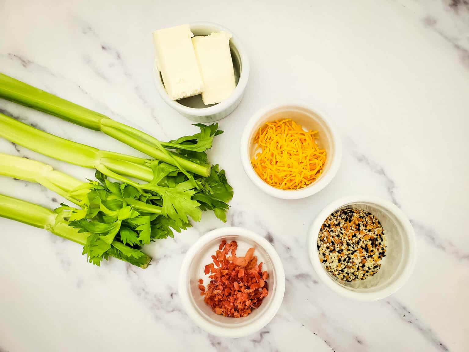 Stalks of celery, cream cheese, bacon bits and herbs.