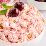 A white bowl filled with cherry fluff salad.