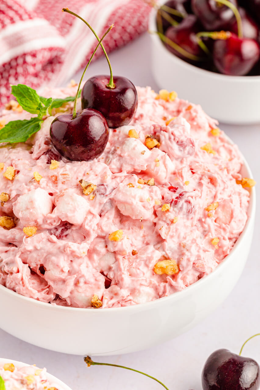 A white bowl filled with cherry fluff salad.