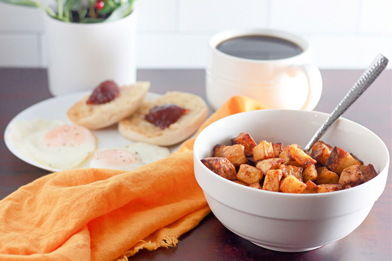 A view of air fryer crispy breakfast potatoes with an orange napkin