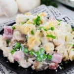 A bowl of the egg noodles, peas and ham.