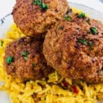 Taco stuffed meatballs on top of spaghetti.