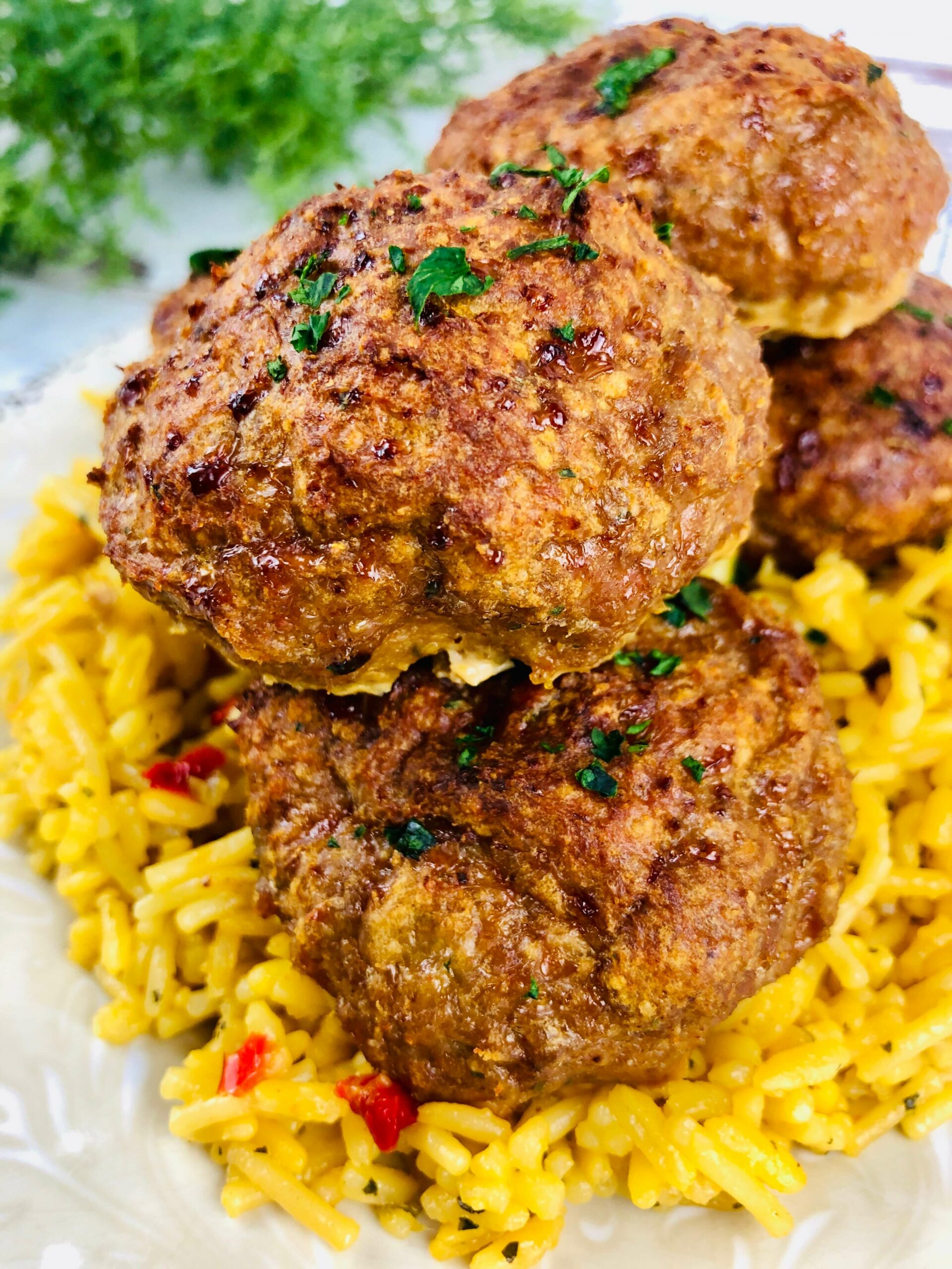 Taco Stuffed Meatballs on a bed of Mexican rice.