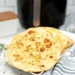 A stack of air fryer Garlic Naan Bread.