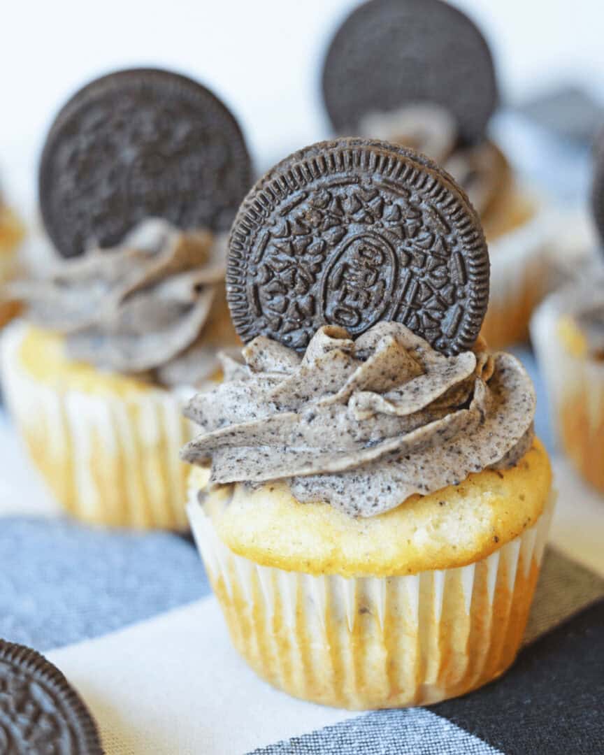 Finished cookies and bream cupcakes with an oreo on top,